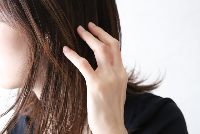 髪の毛を触る女性